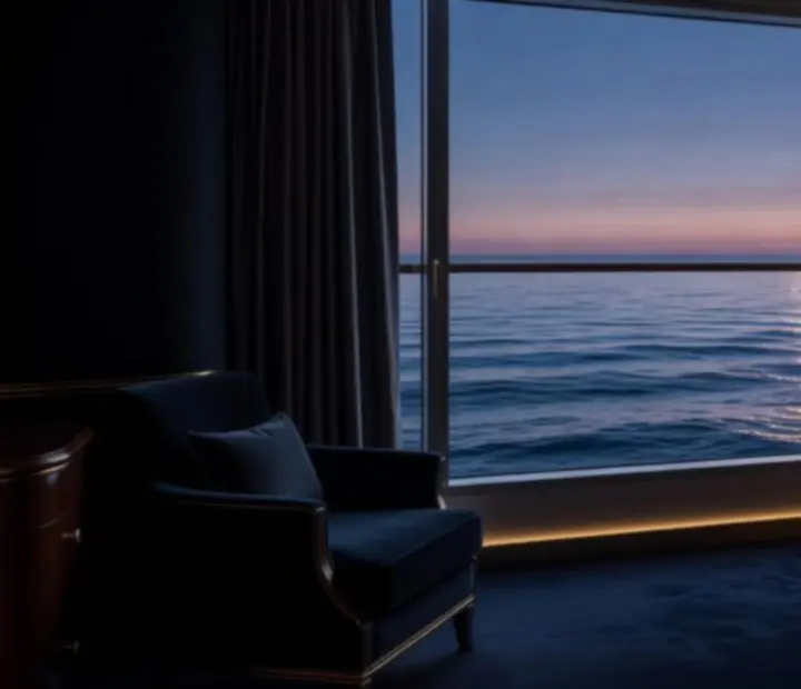 Luxury cabin interior framing a twilight ocean view through large windows